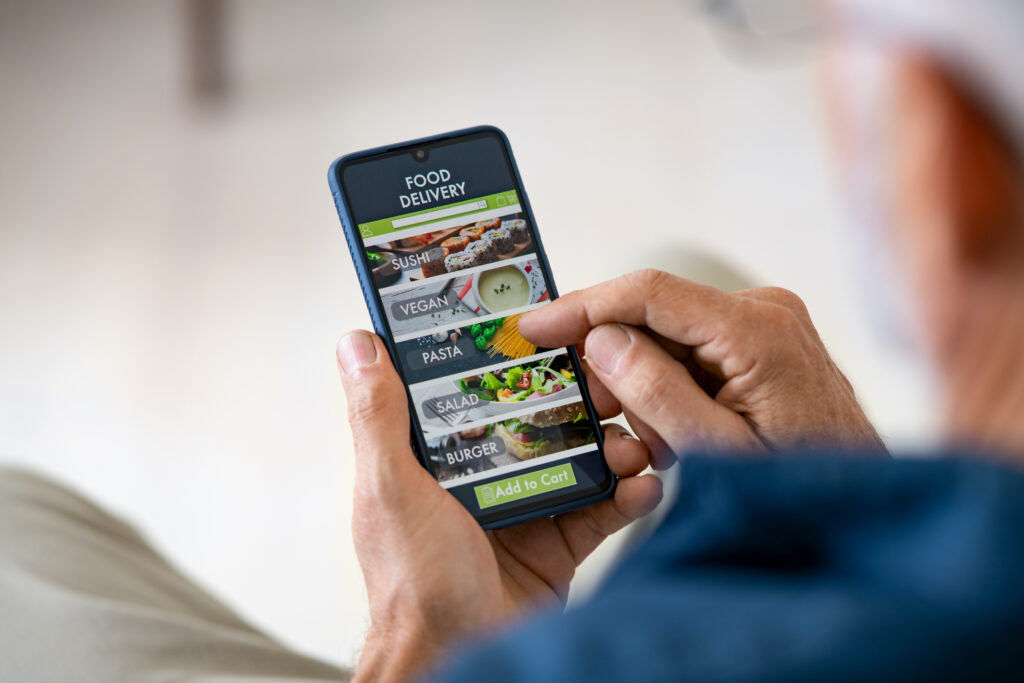man uses mobile apps to order food